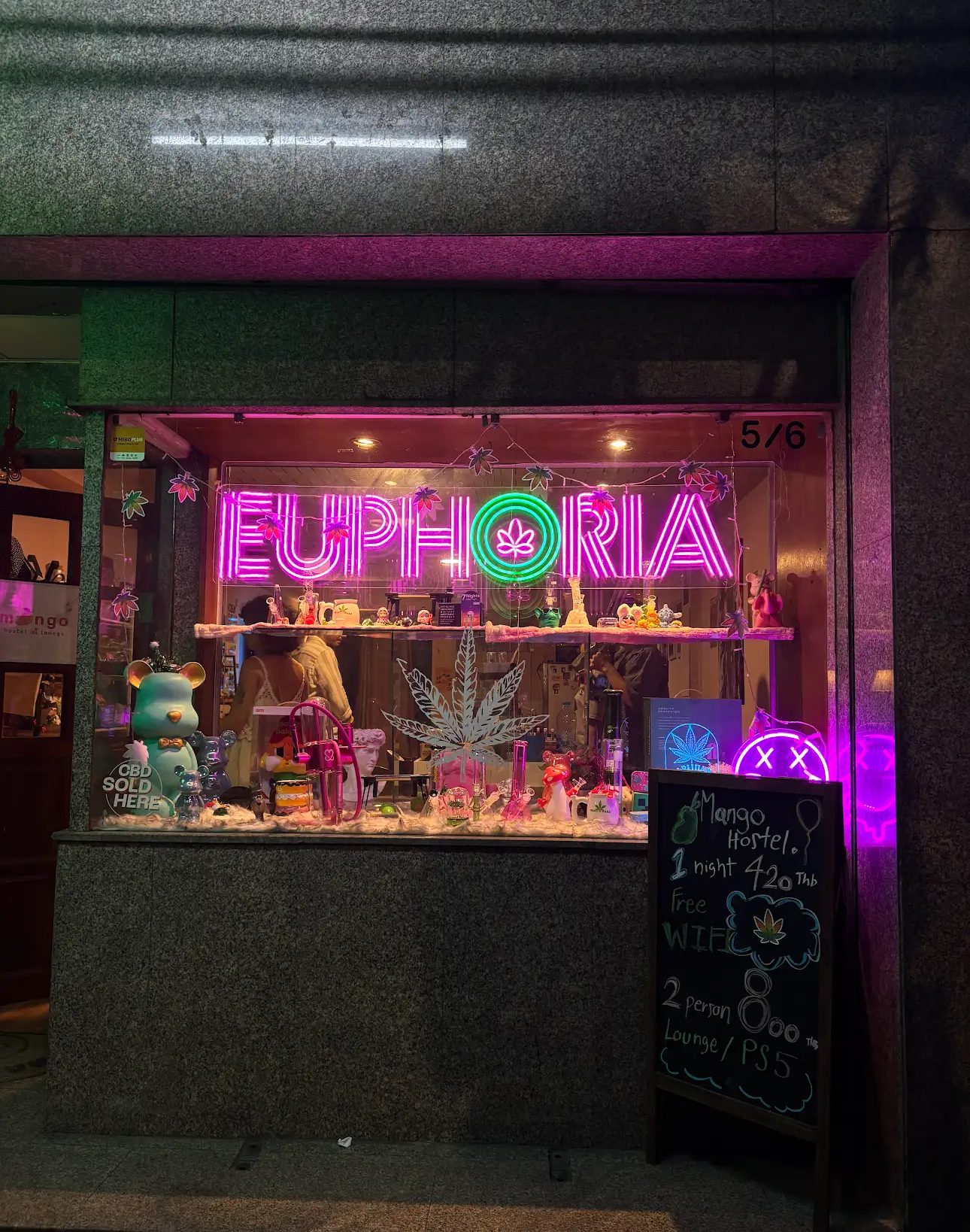 Euphoria cannabis dispensary neon storefront sign lit up at night in Silom, Bangkok